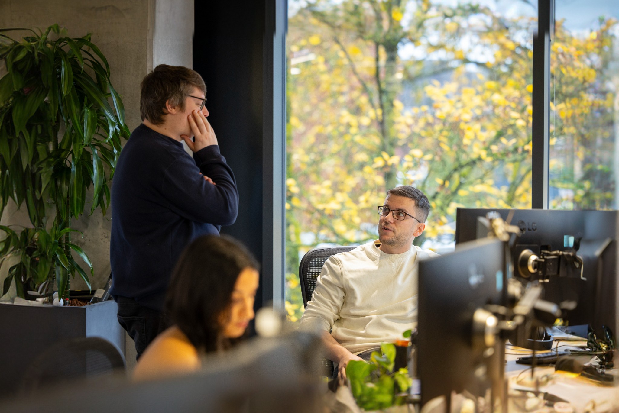 Team members talking to each other in an office setting